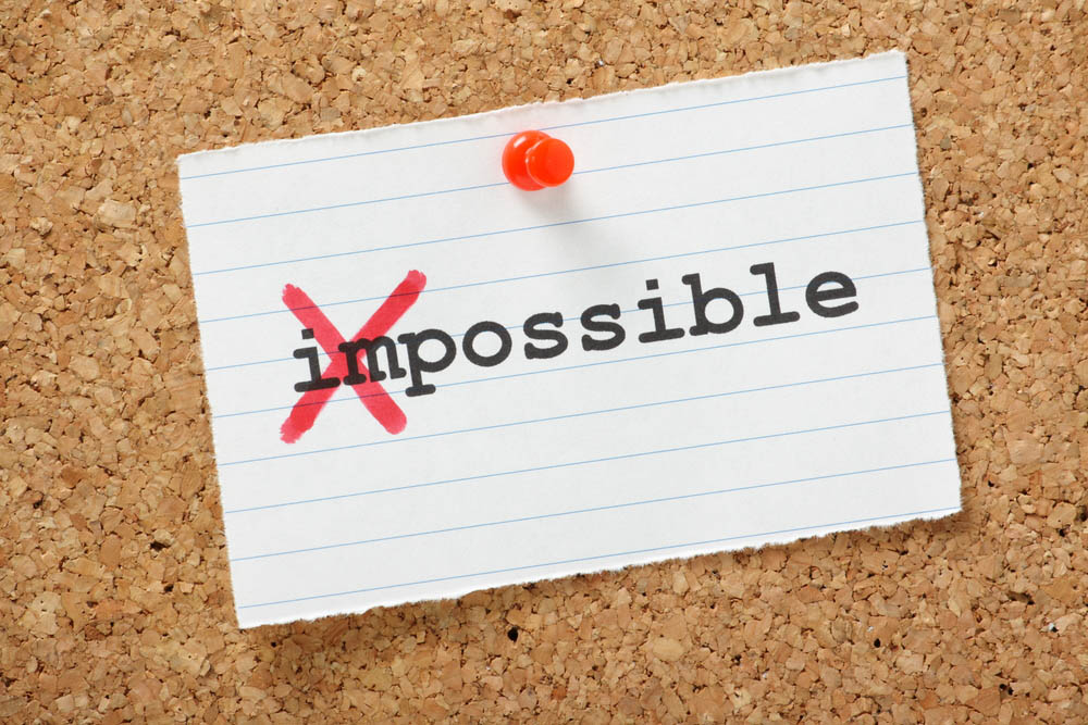 The word impossible with a red cross through the first two letters so it read possible