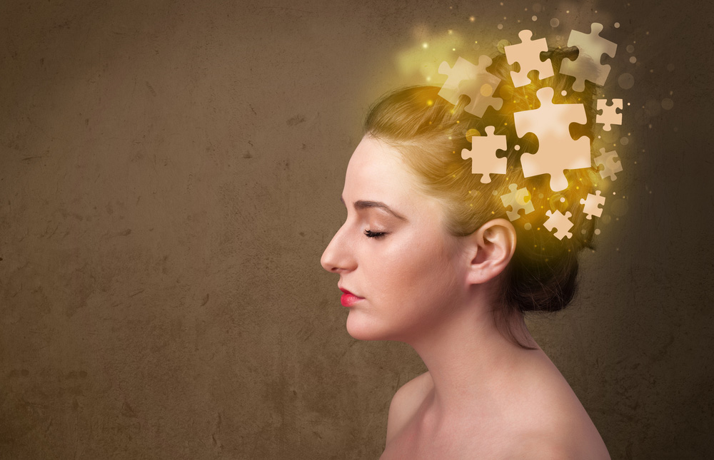 A girl with jigsaw puzzle pieces around her head