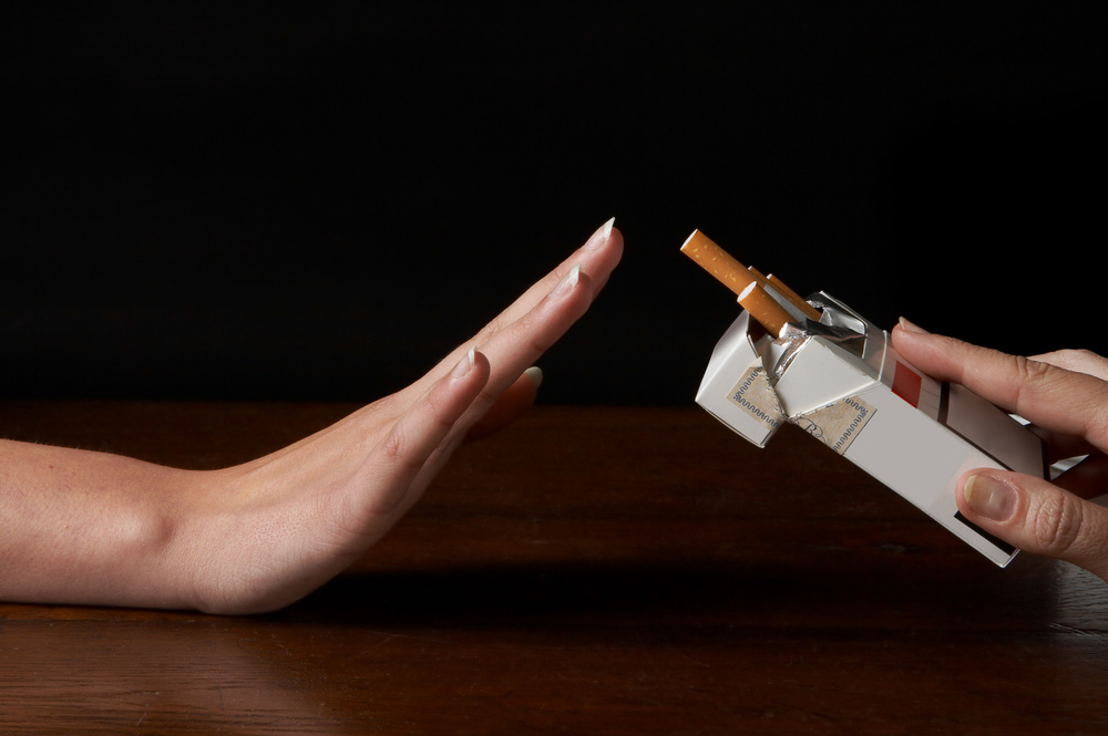 A hand saying no to a cigarette
