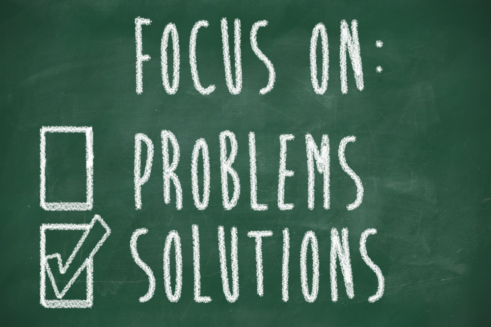 A chalkboard saying problems and solutions